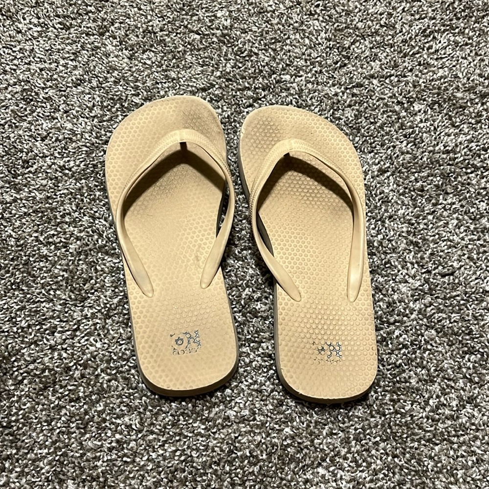 Tan flip flops